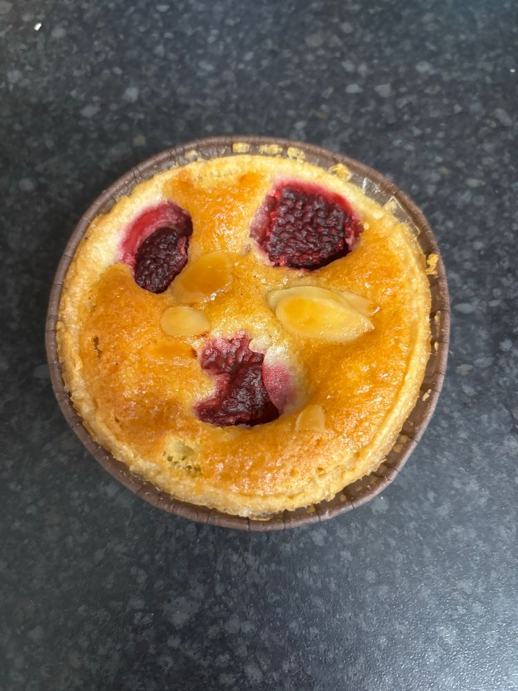 A Bakewell tart from Sainsbury’s, the three cherries on the top look like two bloody eyes and a stretched, anguished mouth.