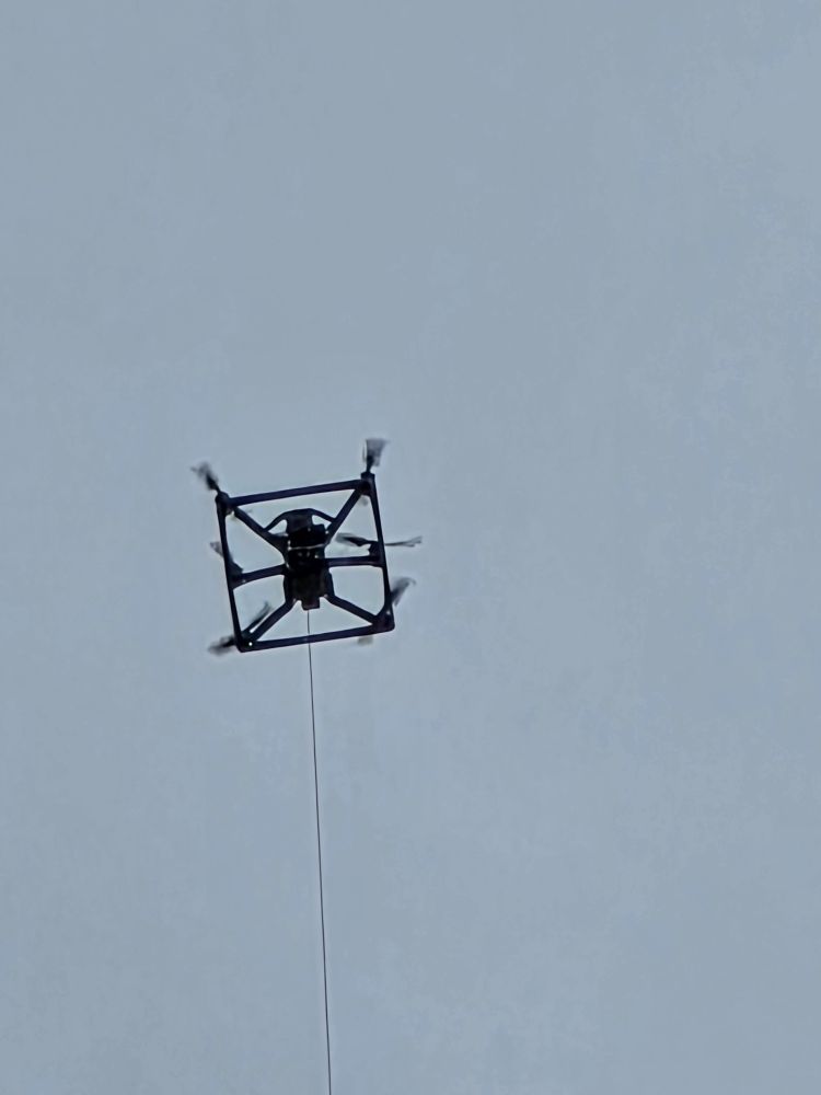 Tethered drone flying over the demonstration. 