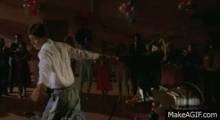 Animated Gif showing a man and woman doing bicycle tricks during the bicycle boogie dance scene in the movie, Rad. 