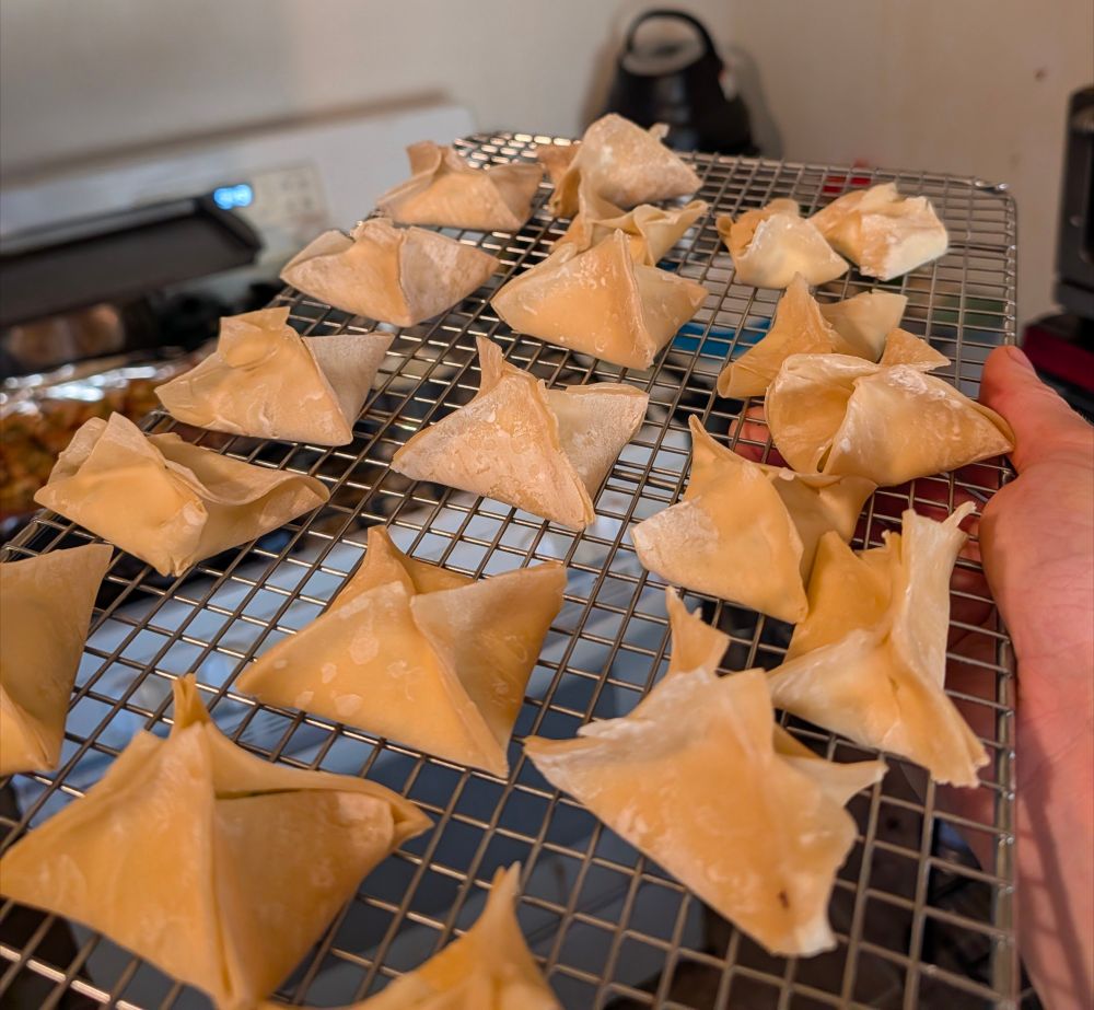A cooling rack of inexpertly handcrafted homemade Crab Rangoons