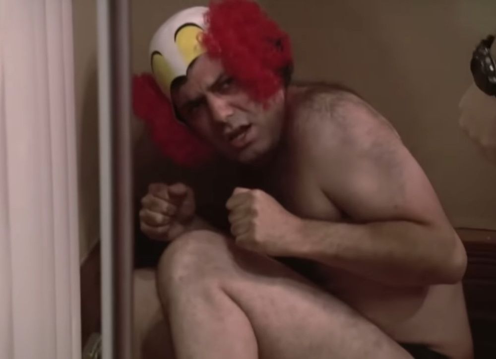 Kenny Hotz in his underwear and a clown hat / bald cap thing, cowering in a corner with tightly clenched fists (I think Spenny is hitting him with something in this clip)