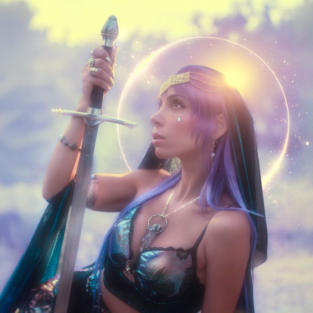 Album cover for "Songs From My Castle Tower" by MJ Noble. It shows the artist in a sort of modern/medieval outfit with purple hair, holding a sword by the handle upside down, looking off into the distance, with a glowing sun around her head