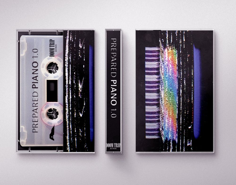 marc junker prepared piano tape - clear tape. cover art is a piano glitched out with static and colors against a black background 