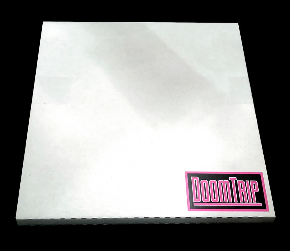 a photo of a "record mailer" cardboard box with a Doom Trip records sticker in the bottom corner. the mailer is white, clean, against a black surface. it likely contains an Nmesh 2xLP for The Molokai Compendium 