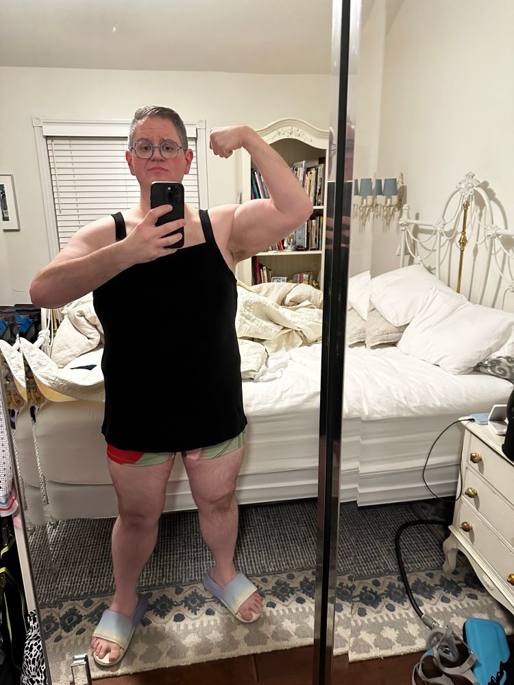 Me stupidly flexing in my hot tub attire