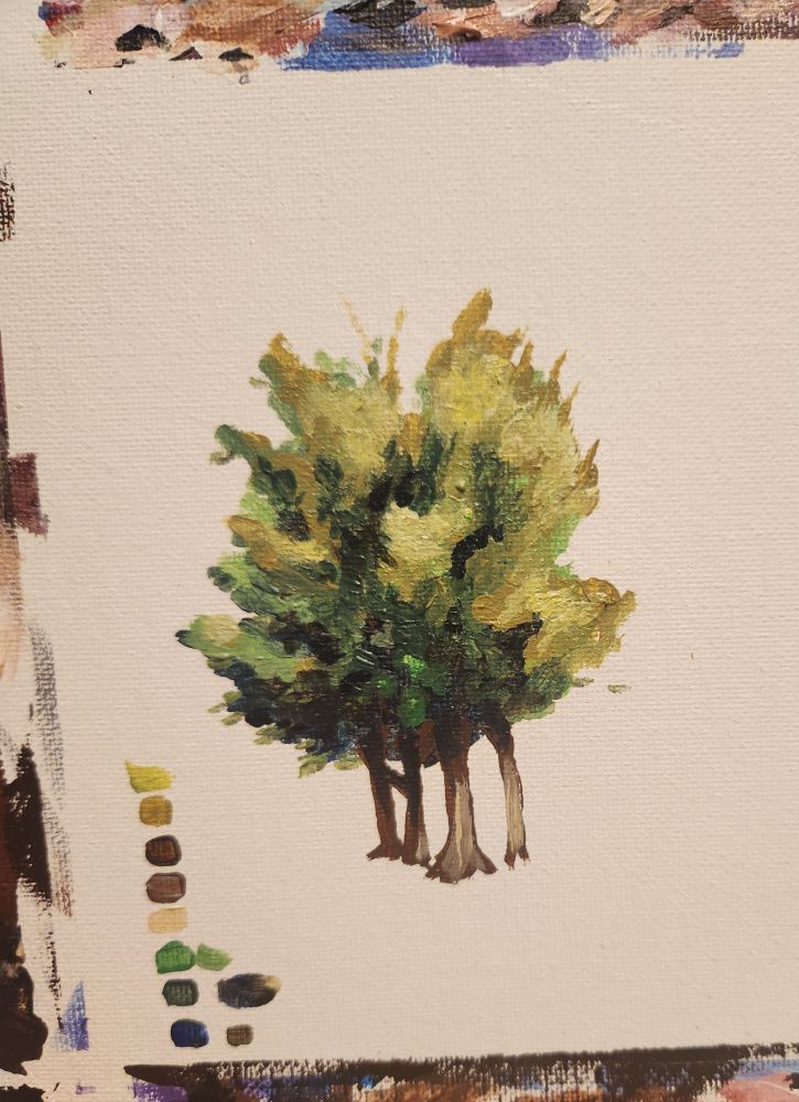 A little acryllic painting of a tree on a bit of illustration board. Next to it are a few colors in a guide