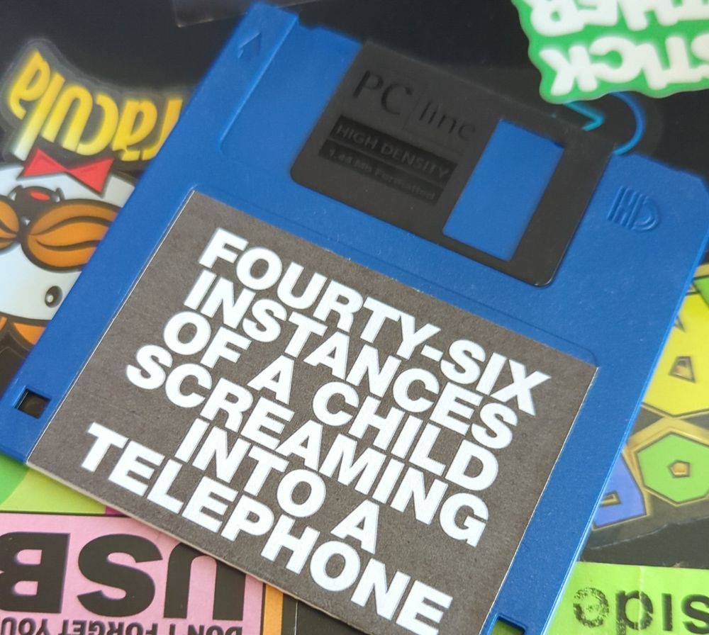 A floppy disk that reads 'FOURTY SIX INSTANCES OF A CHILD SCREAMING INTO TELEPHONE