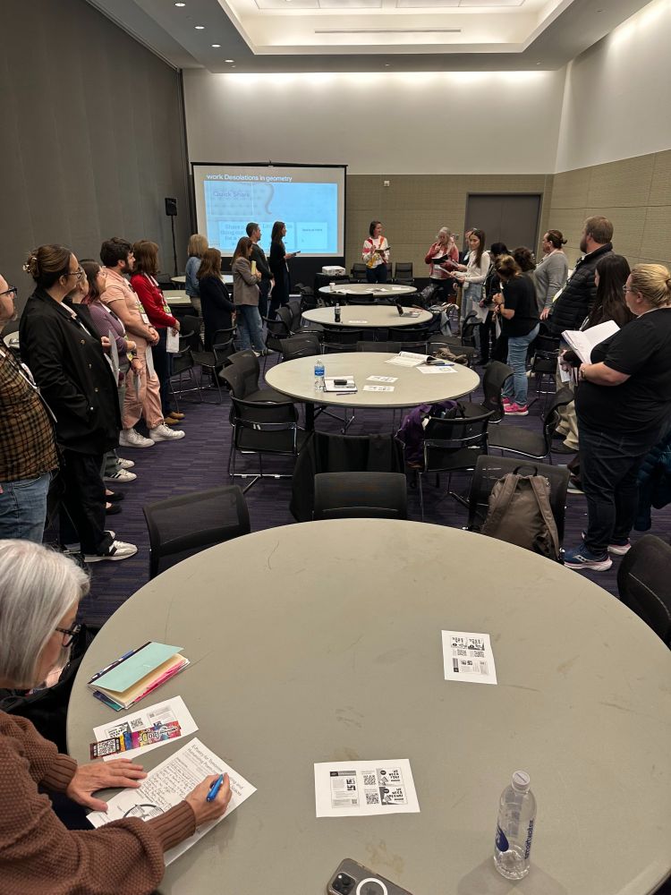Teachers stand in a circle to create poetry.