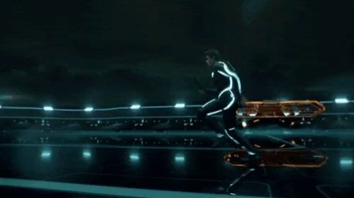 a futuristic motorcycle is flying through the air on a dark background .