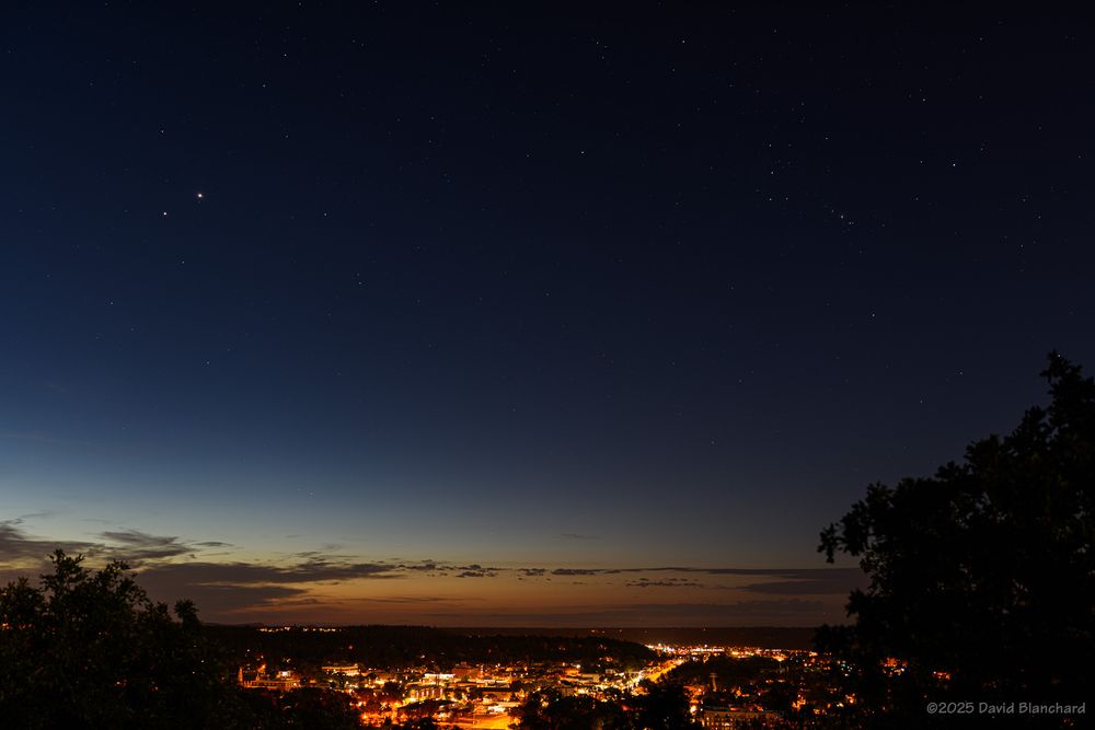 Jupiter and Venus share the morning twilight sky. The two planets are the bright objects in the upper left. In the upper right is Orion. 