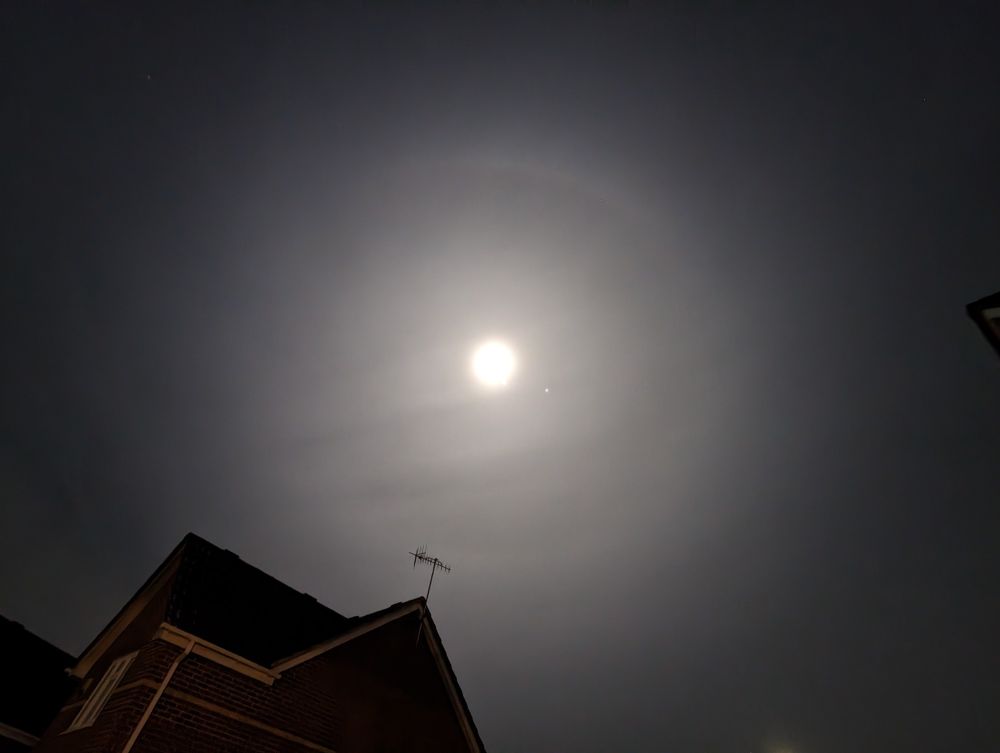 Photo shows a faint large ring around the moon