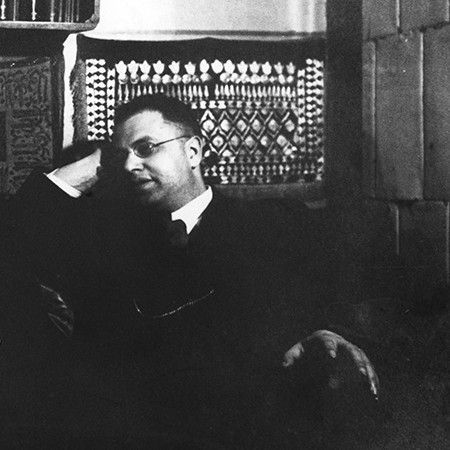 Photo of Boris Yarkho (1889-1942), one of the few ones that are discoverable on the web; he is sitting on a chair, leaning sideways and smiling. 