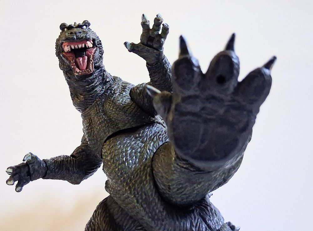 An eneaged GMK Godzilla with his massive stomper raised, about to crush the camera woman (me help.)