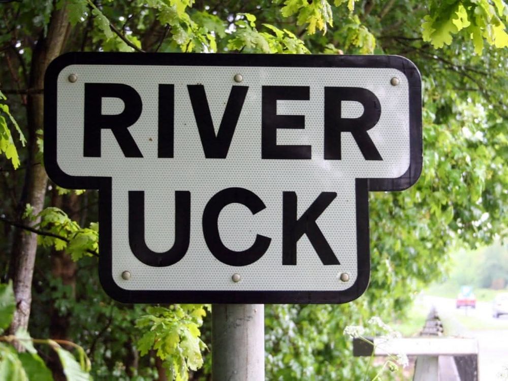 River Uck sign. River up top. Uck below. Designed to fit each word exactly.