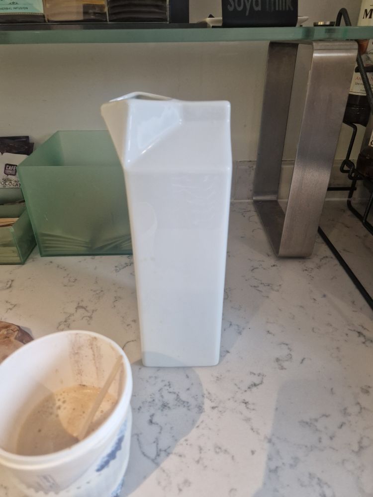 Ceramic milk jug in the shape of an open carton. 