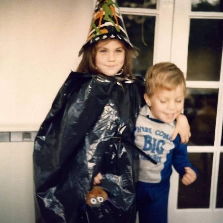 Unrelated photo of me and my brother as kids at Halloween. I am dressed as a witch with paper hat and bin bag. He isn't dressed up, it must have been a school thing. But he has a very 80s here comes big trouble jumper on. I have my arm around him so not entirely unrelated. 