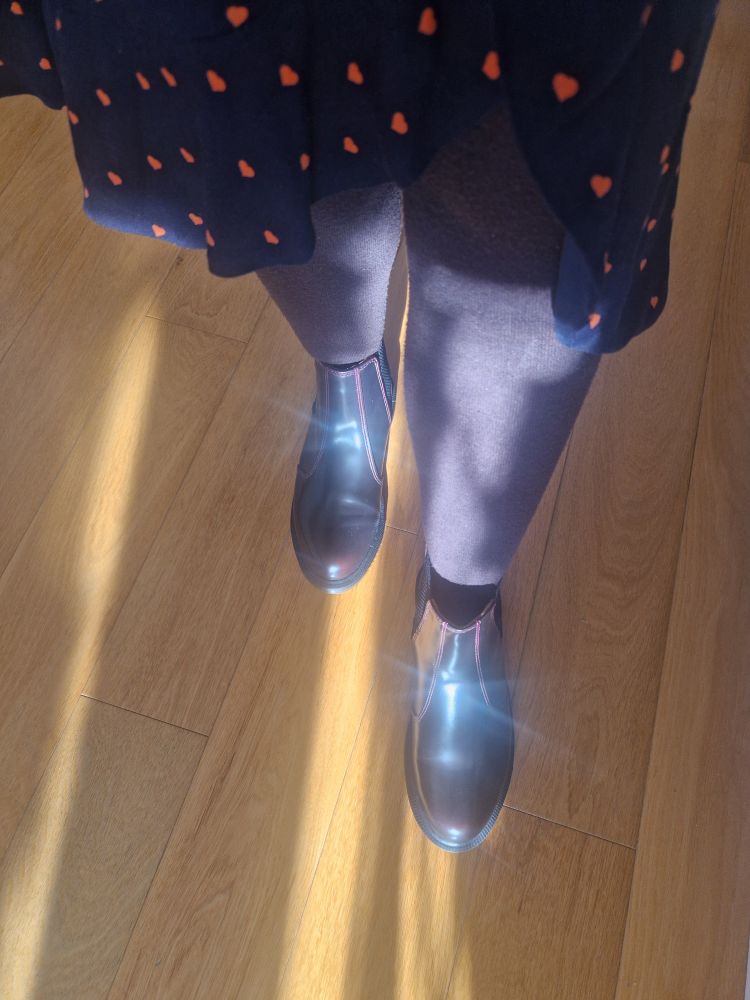 Photo of my dark red doc martens. Brown wooly tights and a navy dress woth orange hearts. 