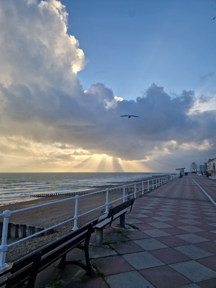 Promenade on the walk home, big cloud with rays of sun pouring through. 