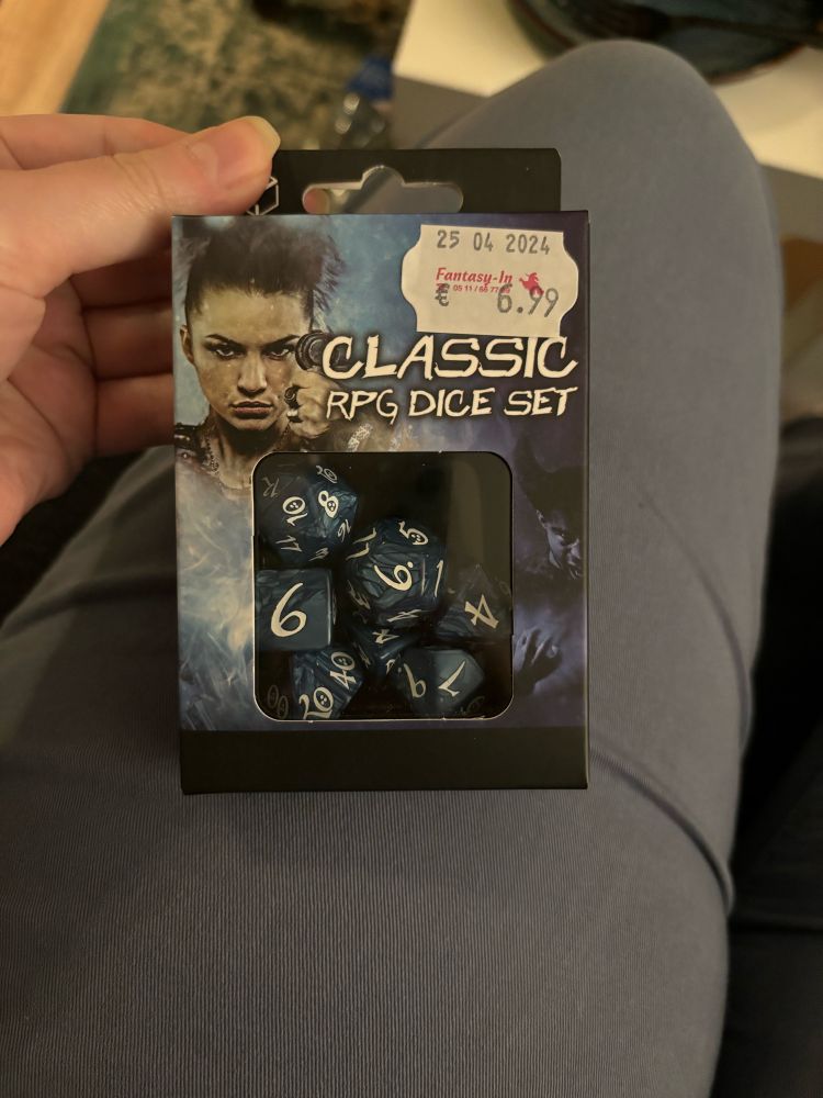The Q Workshop Classic RPG Dice Set in blue marble with white numbers. It features a 6,99 price tag.