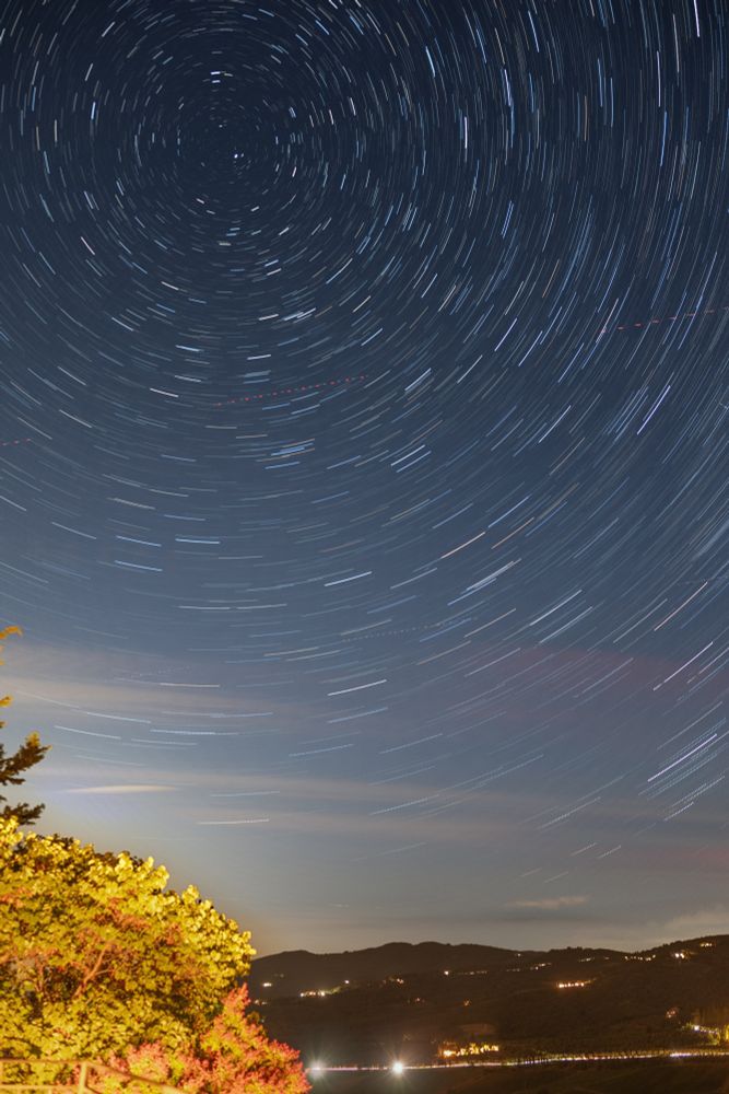 Star trails over Tuscan landscape