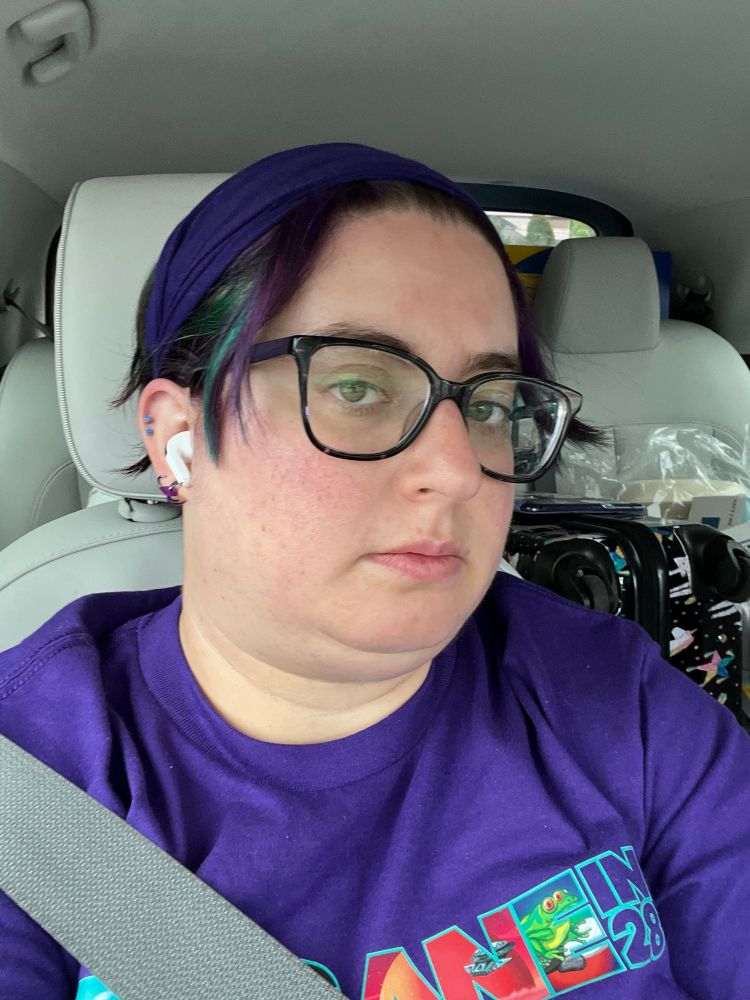 Selfie of a tired woman in the front seat of a car. 