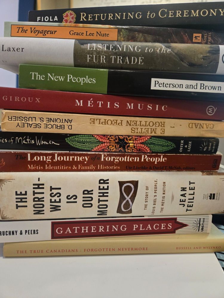 A big stack of books related to Metis culture and history.