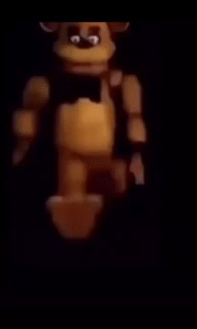 a close up of a teddy bear standing in the dark .