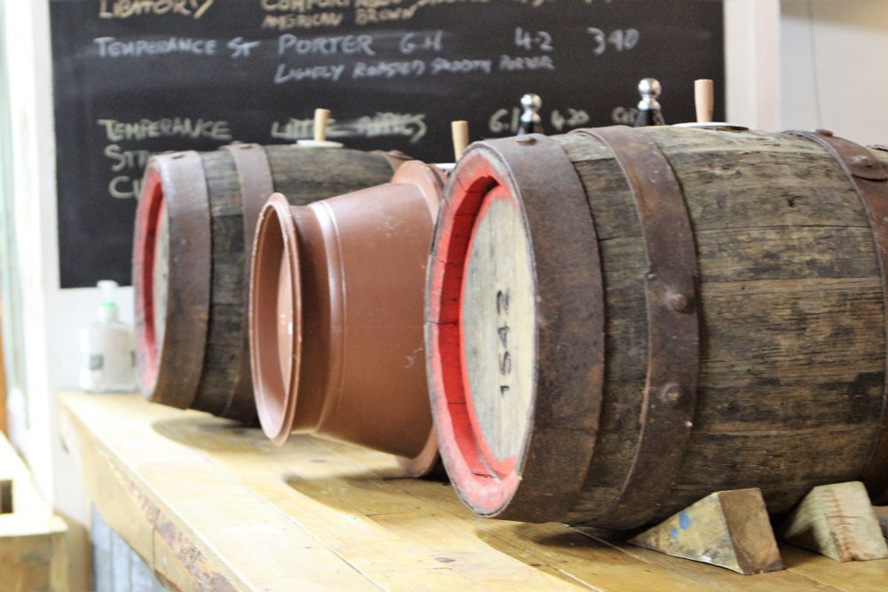 Reused wooden, and plastic, barrels on a bar.