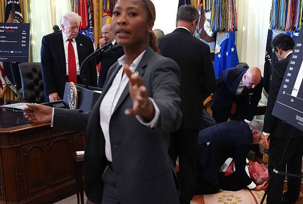 Trump looking at man on ground