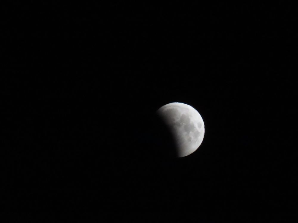 Lunar eclipse 14 March 2025 about a third of the left hand side of the moon is obscured by the earths shadow