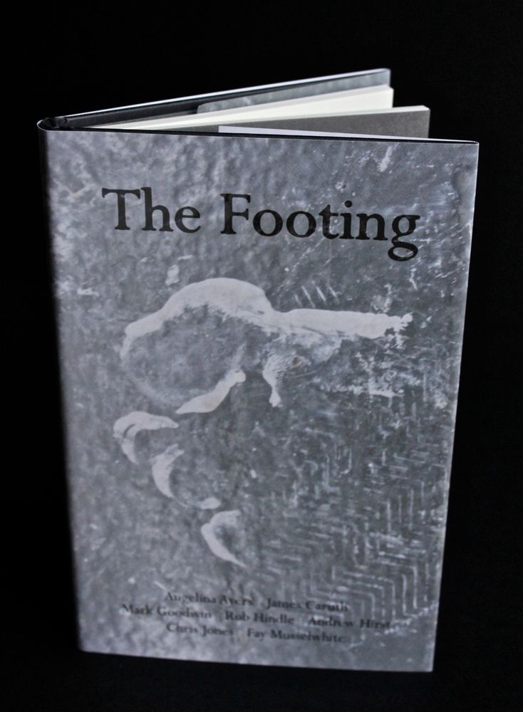 The cover of the Longbarrow Press anthology 'The Footing', featuring abstract grey and white motifs