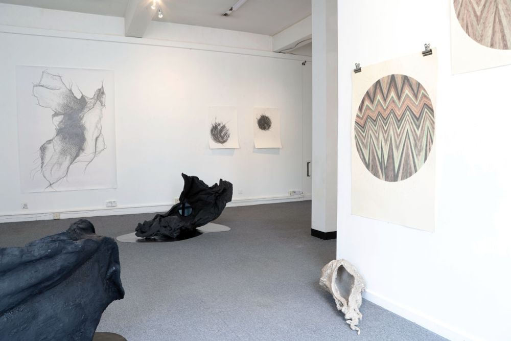 A partial view of the Salon #2 installation, with several wall- and floor-based artworks by Victoria Lucas, Rachel Smith and Emma Bolland in the foreground and background.