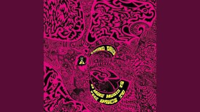 A picture of the album cover for Spaceman 3's "Taking Drugs to Make Music to Take Drugs to".  The album title appears in yellow lettering next to a small yellow pyramid with a black 3 on it. The rest of the album is covered in a reddish, psychedelic style artwork, somewhat reminiscent of a lava lamp.