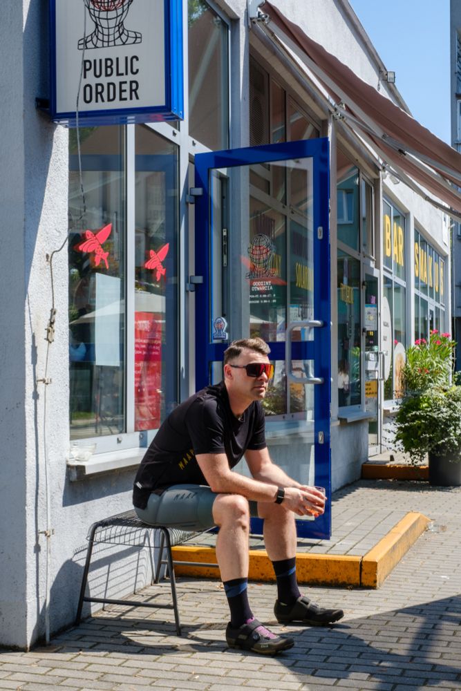 Photograph of Ben in front of Public Order coffee, Krakow. 