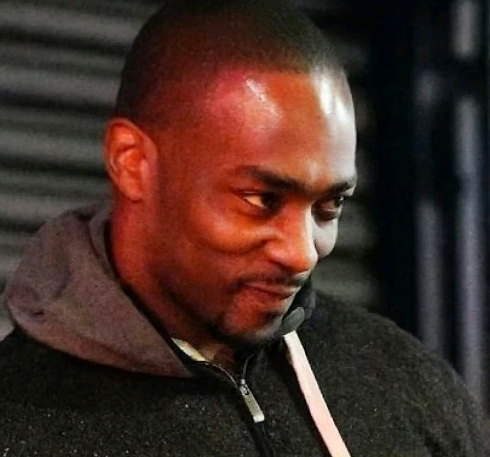 Anthony Mackie doing *that* smiling face. 