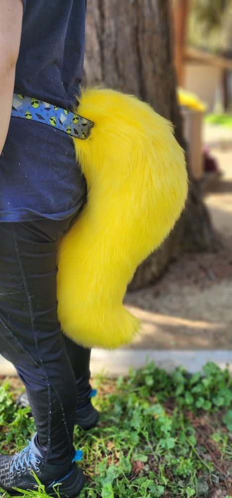 A yellow canine style fursuit tail.