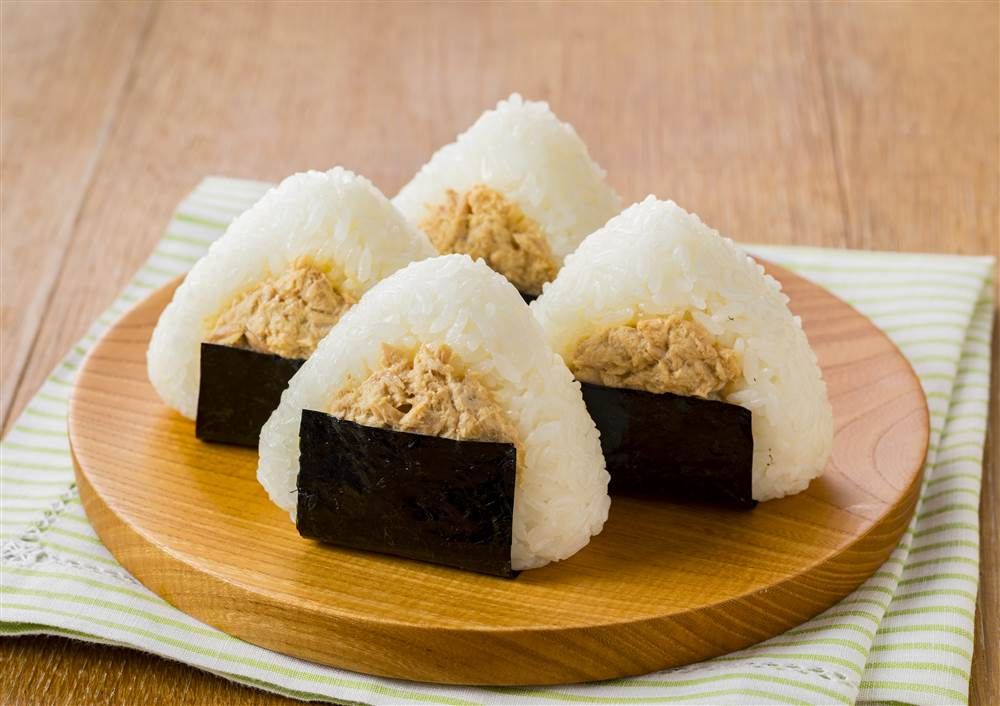 a plate of four tuna mayo rice balls with traditional Japanese flavoring