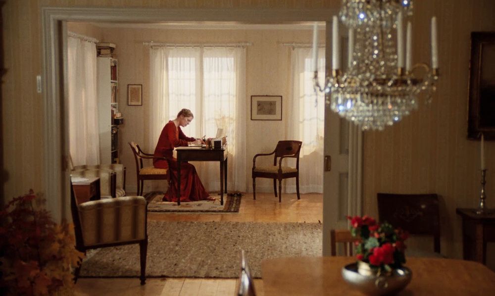 eva sitting at the desk writing