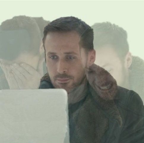 Image of Ryan Gosling staring at a screen and two faded images of Ryan on either said of the main Ryan where he has his hands covering his eyes and then other where he appears to be gritting his teeth