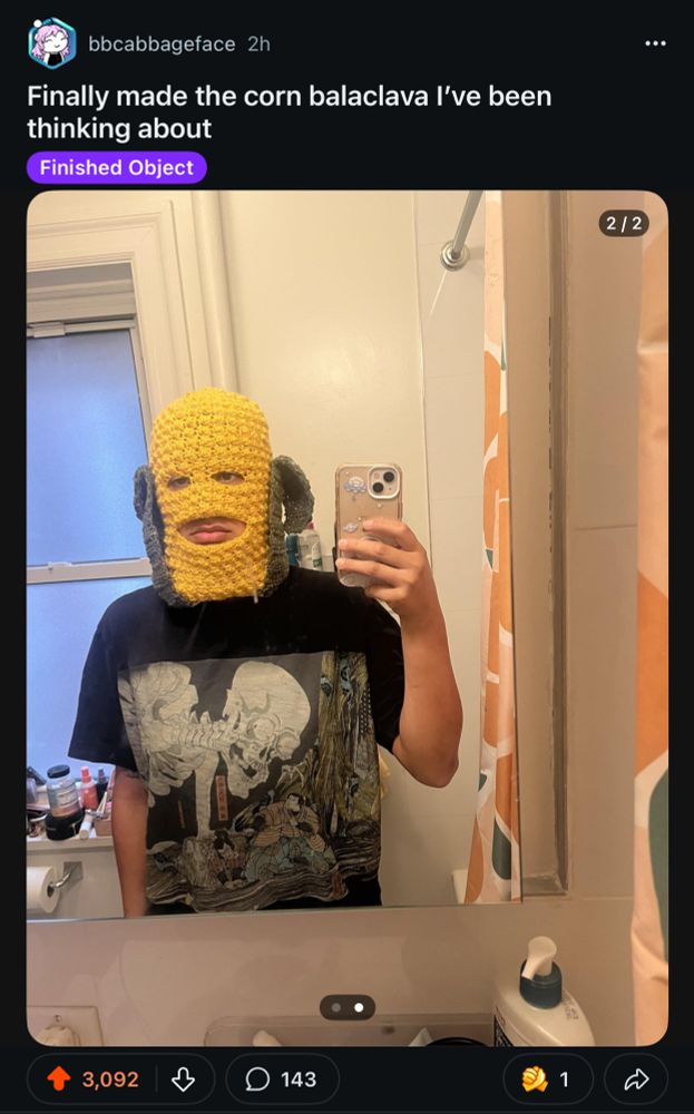screenshot of r/crochet reddit post entitled “Finally made the corn balaclava I’ve been thinking about” with a bathroom selfie of someone wearing a balaclava that looks like a corn cob