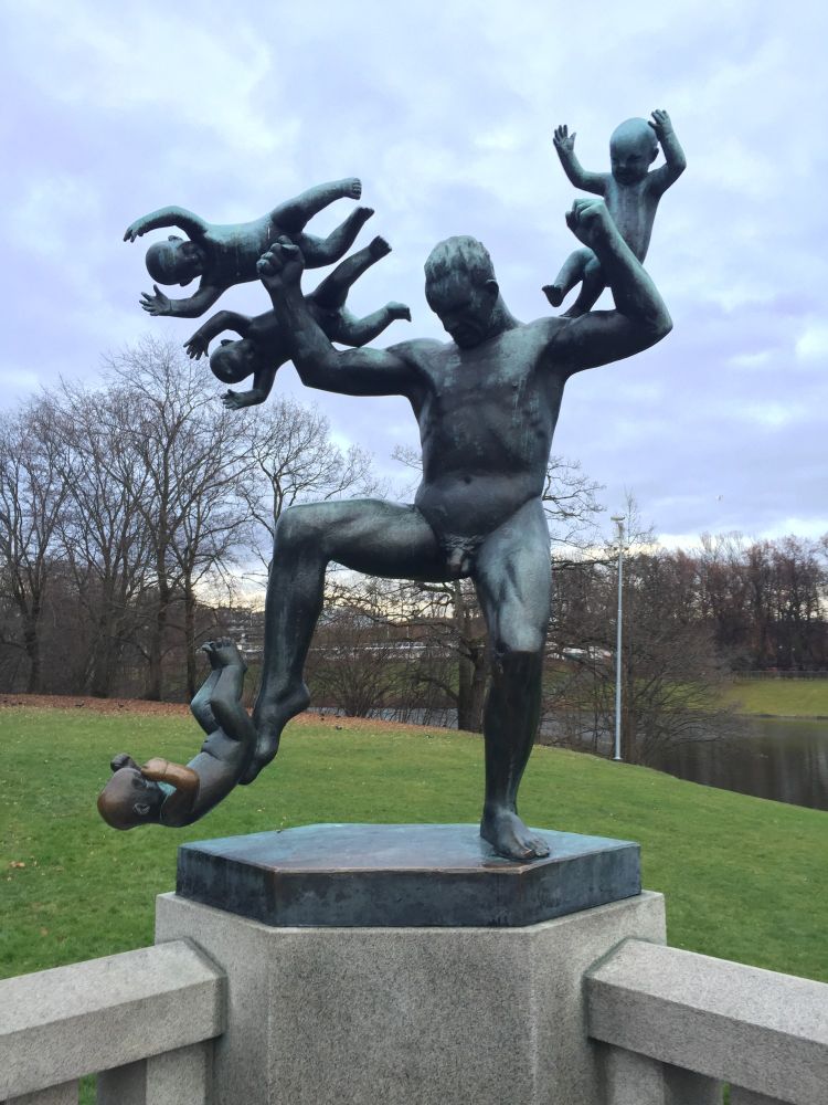 Bronze statue in Frognerparken, Oslo, Norway that depicts a man kicking a baby and throwing 3 others away from himself