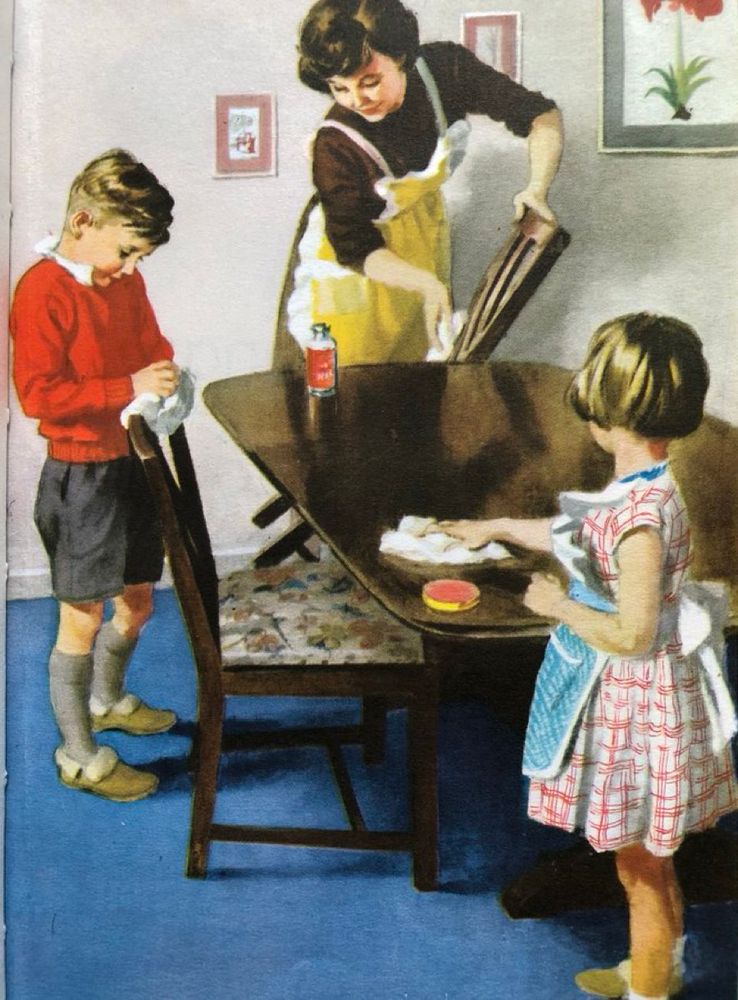 Illustration showing a young boy, neatly dressed in red jumper and grey shorts, and a little girl wearing a blue apron, helping their mother to apply polish to a wooden table