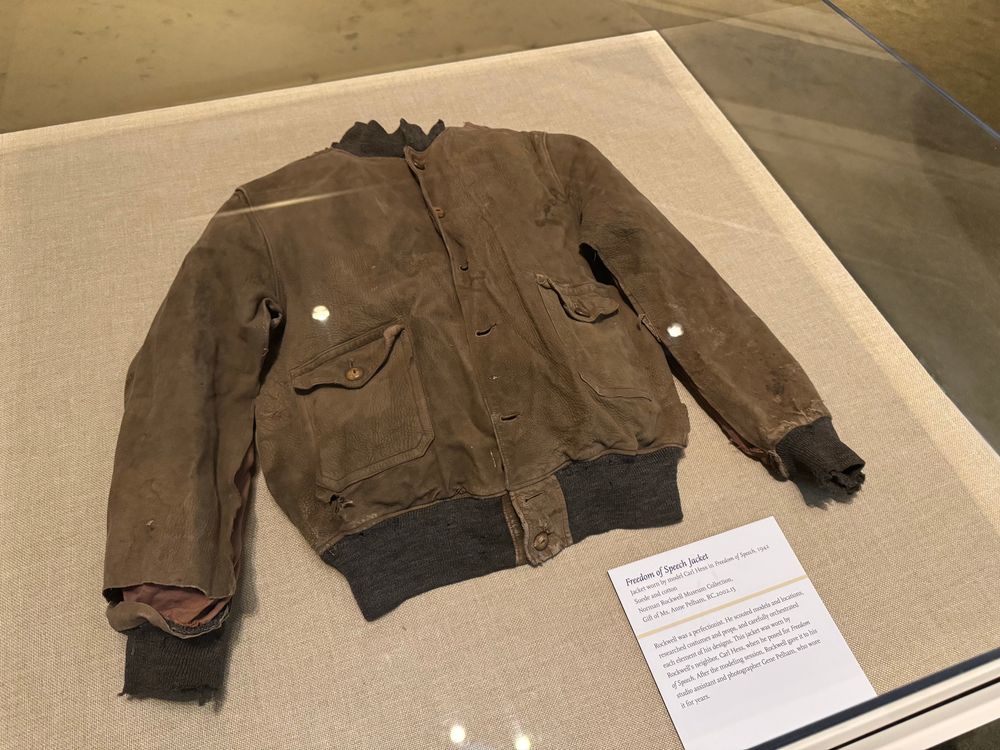 an old jacket in a glass case, which belonged to the model in the painting