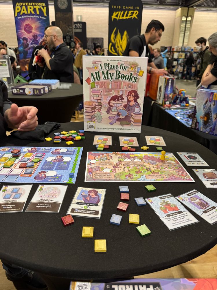 “A Place For All My Books” from smirk and dagger games at PAX Unplugged! Out next January on Kickstarter.