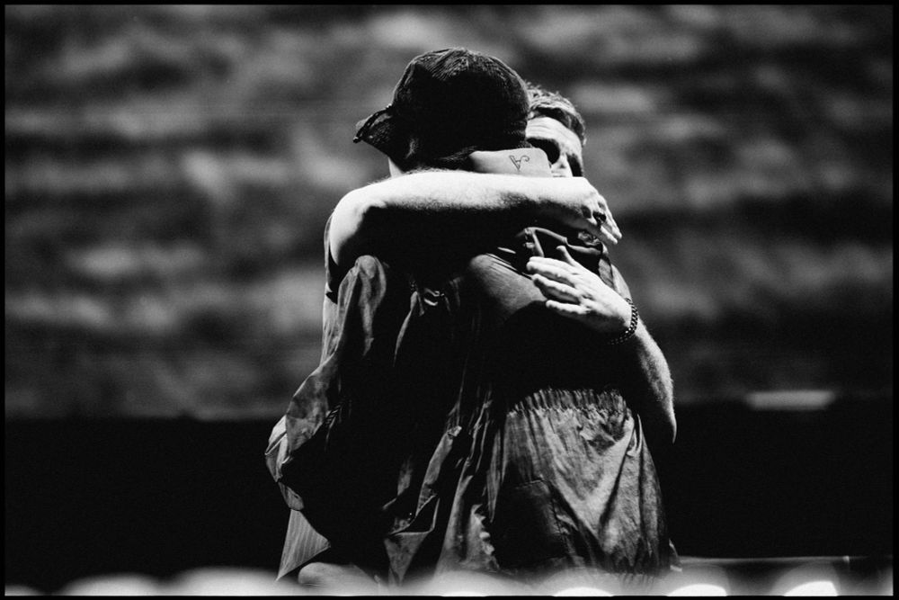 Noel and Liam Gallagher hugging after Wembley Stadium N2 