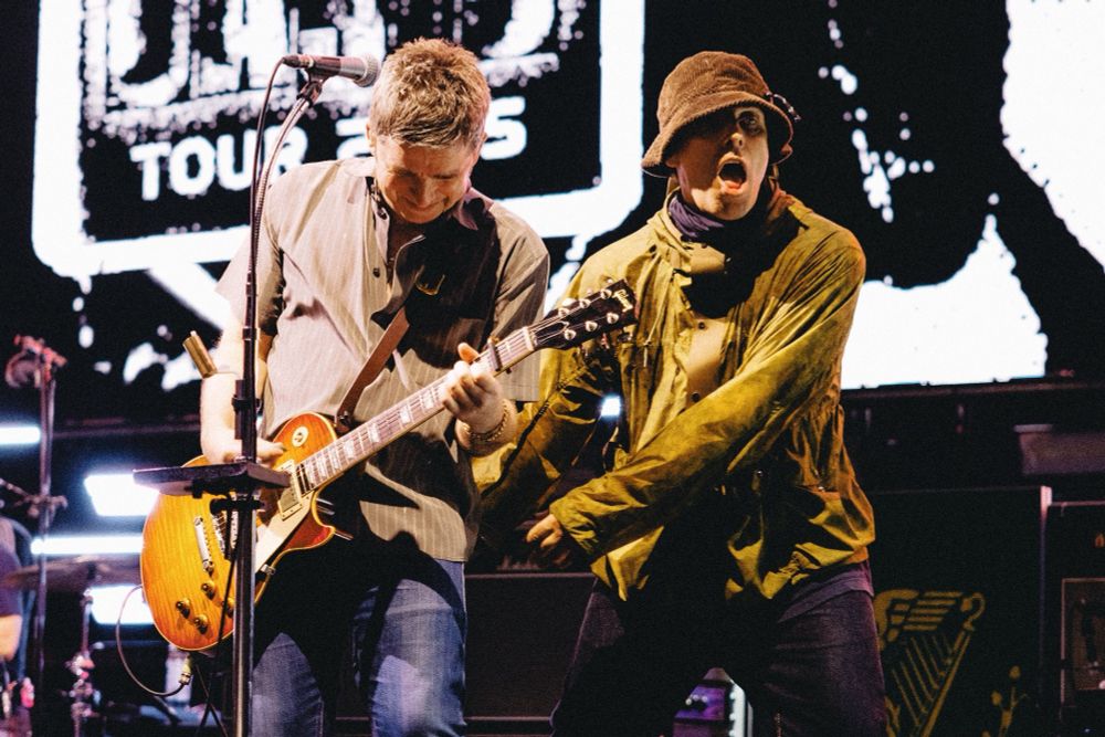 Noel and Liam Gallagher at Wembley Stadium N2 doing...whatever this weird laughing and strangely adorable fucking around while Noel's playing thing.