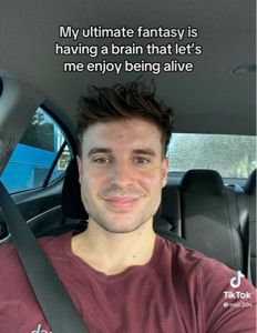 picture of a guy inside a car with sub saying “my ultimate fantasy is having a brain that let’s me enjoy being alive” 