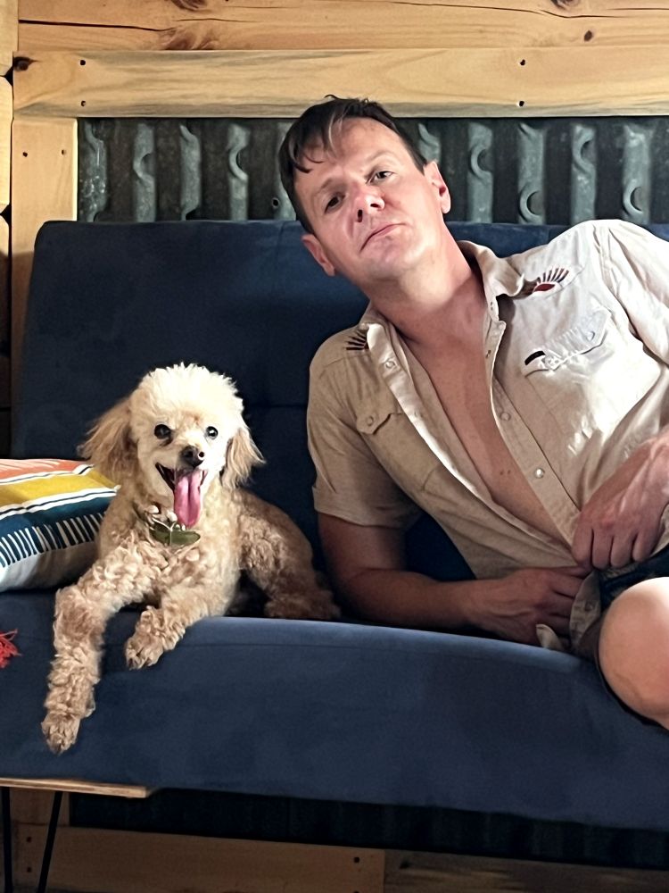 Photo of my poodle and I sweating it out in an Amish cabin.
