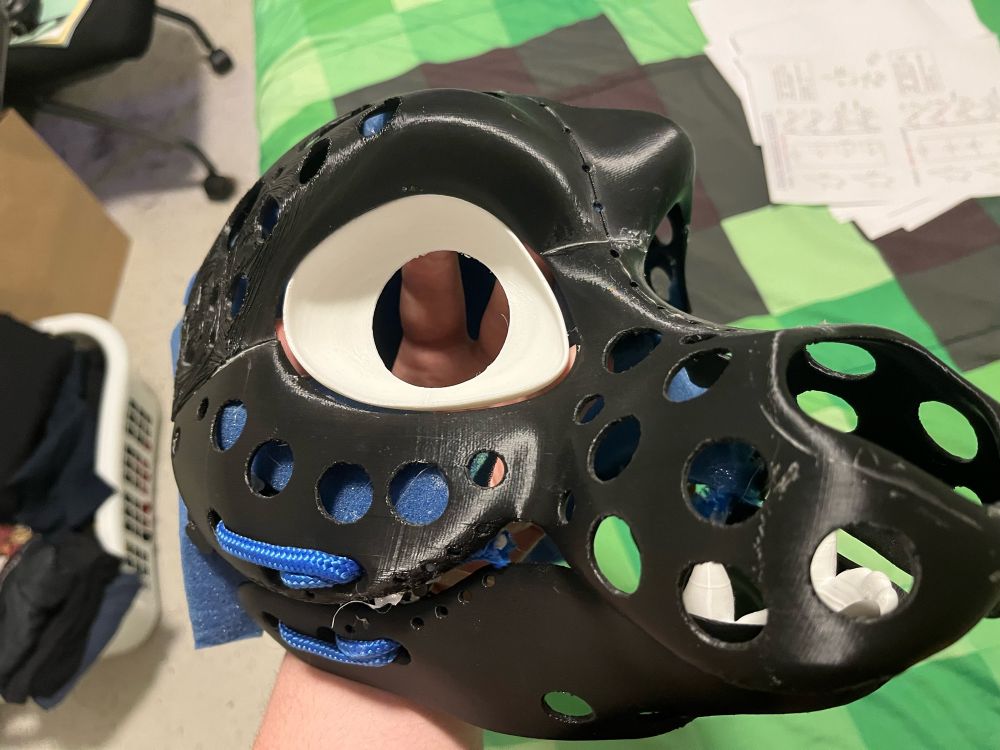 Work in progress fursuit head with the eye insert held in the eyesocket