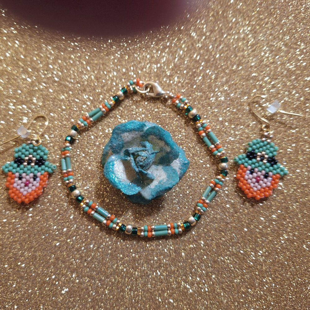 Tiny leprechaun earrings. He has a green hat with black and gold buckle and orange beard. Braceletin same colors. Earrings are 25 mm/1 inch tall without findings. 